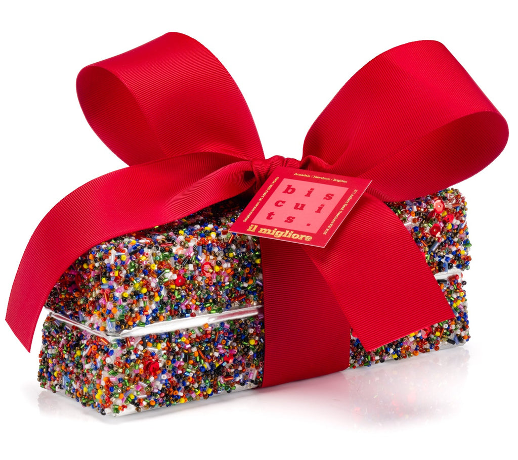 A beautiful tin with a red ribbon covered in colourful beads and sequins