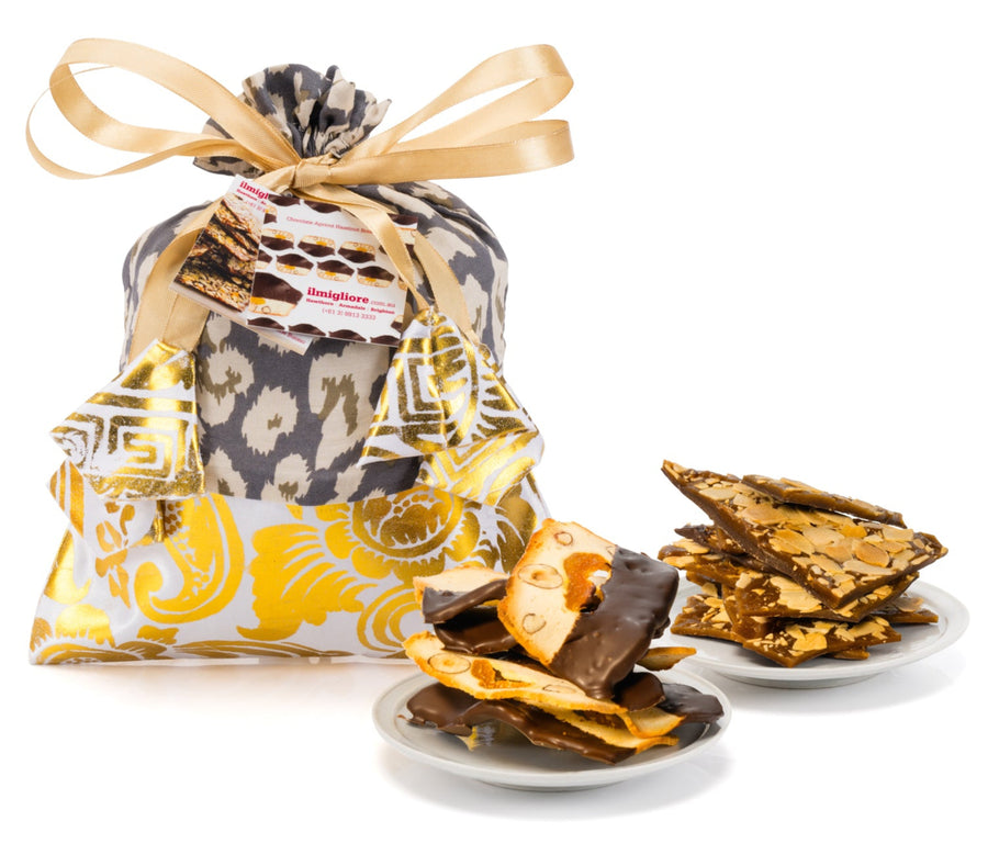 Gift bag with leopard print design and delicious biscuits on a white background