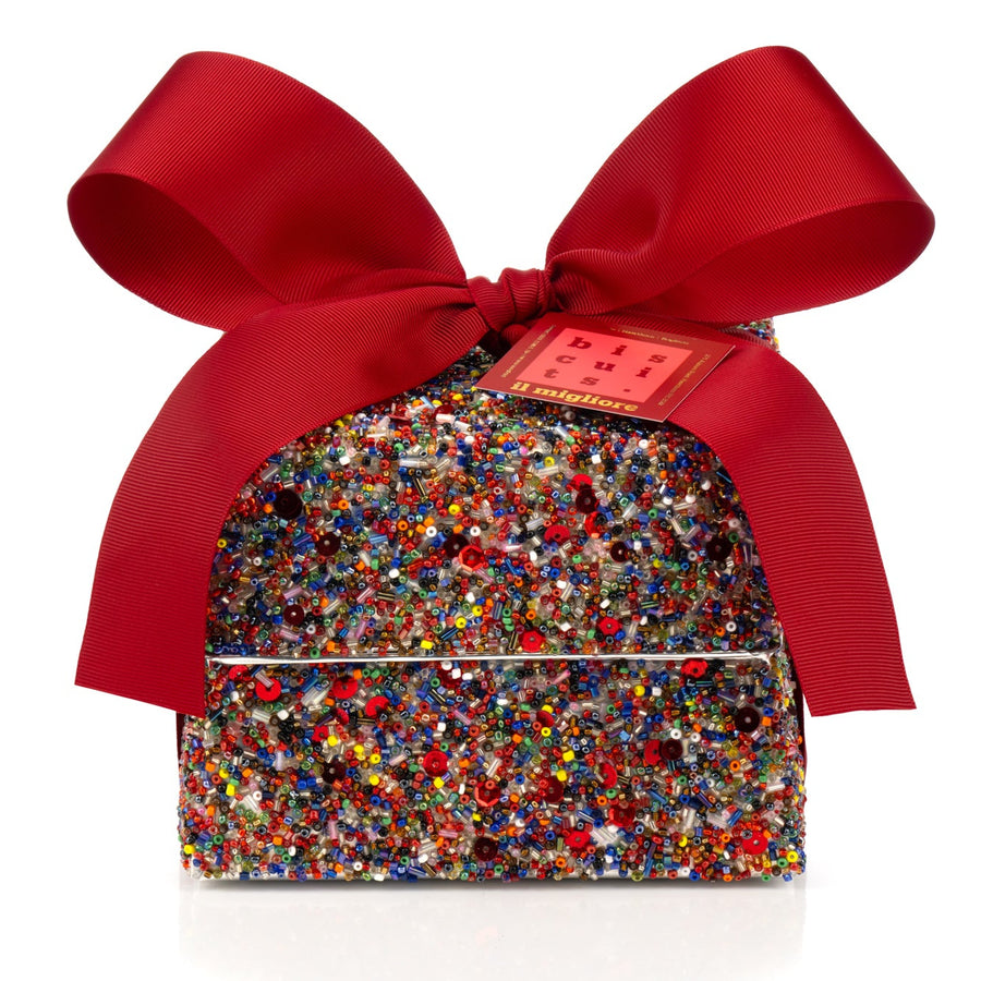 Decorative sequin box with delicious biscuits and a red ribbon on a white background