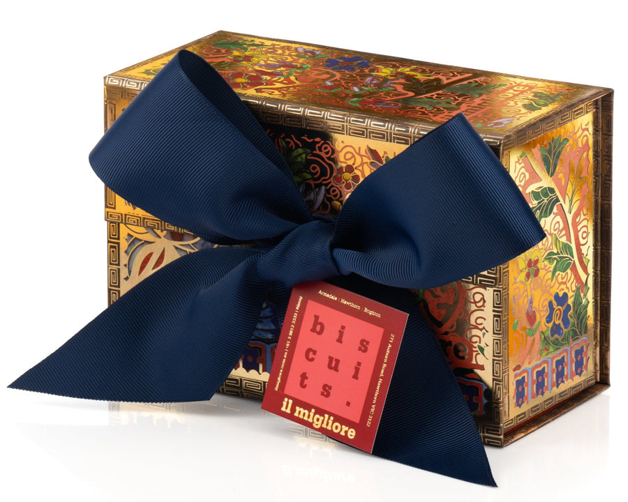 Decorative box with a blue ribbon and a small red label on a white background