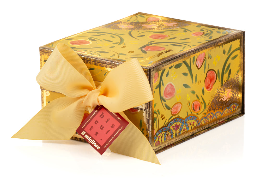 Decorative gift box with floral design, yellow ribbon, and red tag on a white background