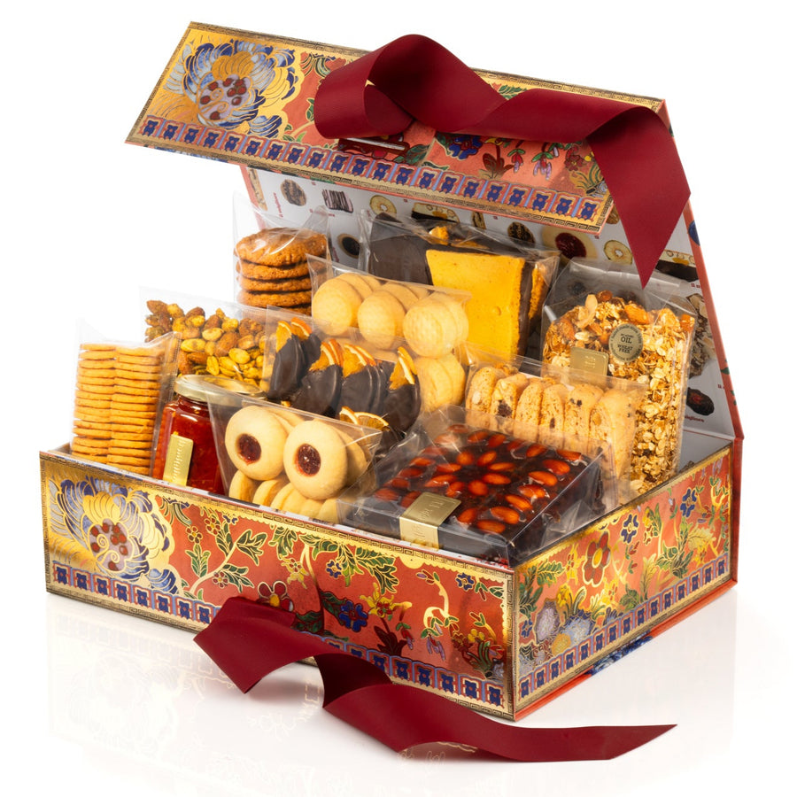 Gift box filled with delicious biscuits and chocolates on a white background