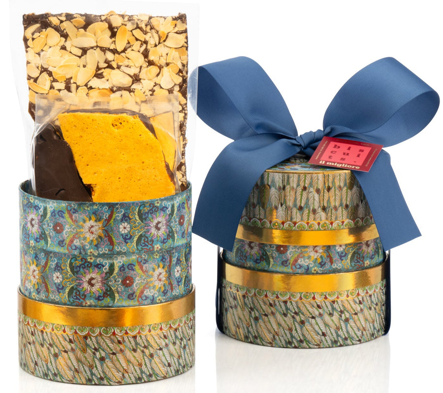 Decorative box with delicious biscuits and a blue ribbon on a white background