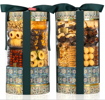 Three cylindrical gift boxes filled with assorted chocolates and biscuits on a white background