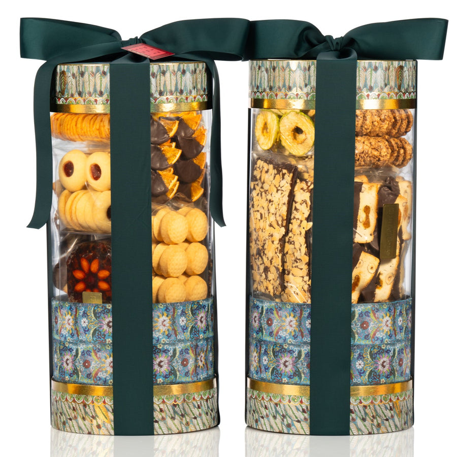 Two cylindrical gift boxes with a green ribbon on a white background