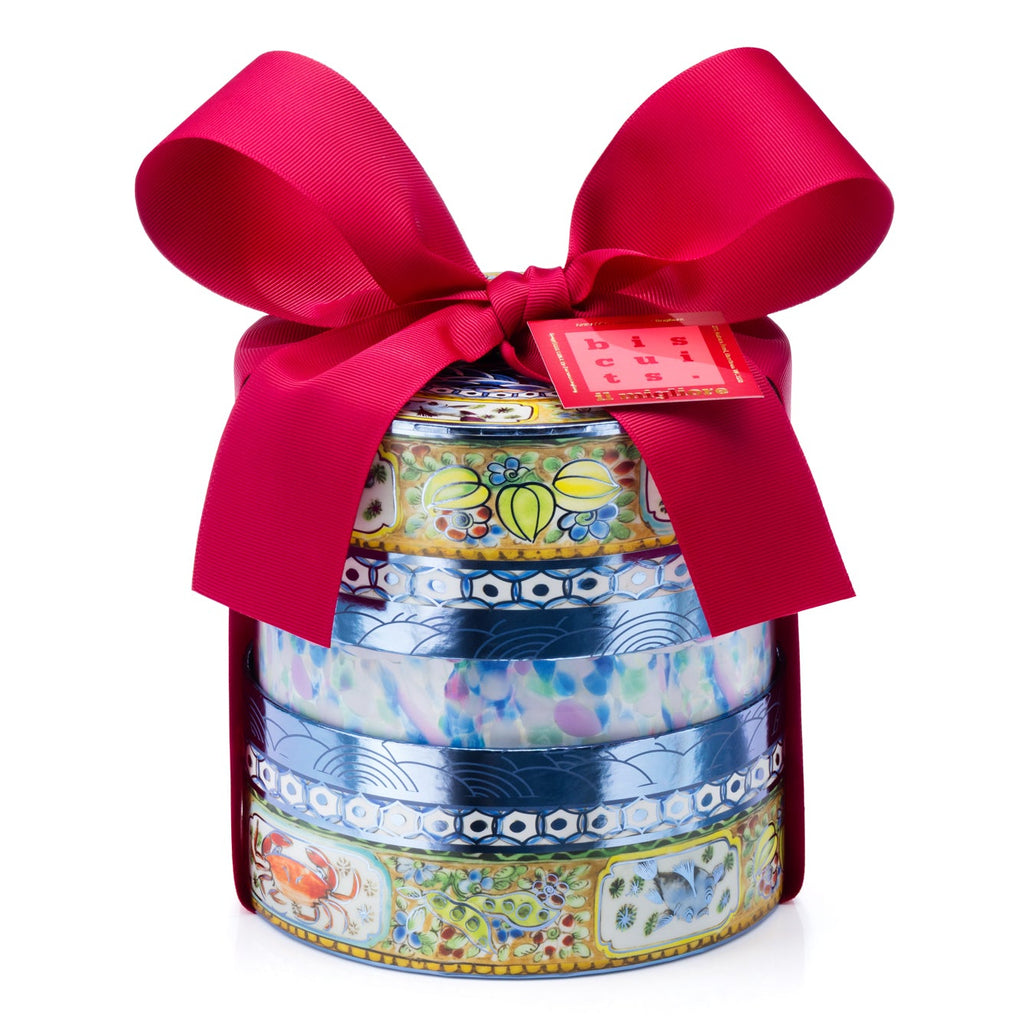 A stack of three round, patterned gift boxes tied with a large red satin bow and a small red tag, photographed on a clean white background.